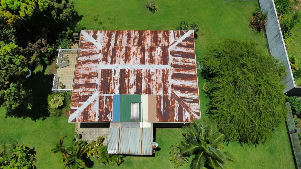 Toiture en tôle rouillée vue du ciel, avant travaux